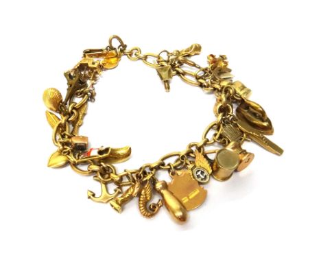 A gold, oval and circular link charm bracelet, fitted with a variety of mostly gold charms, including an aircraft carrier, a 