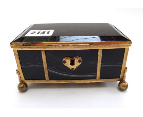 An agate and gilt metal mounted trinket box, standing on four ball feet, 13cm wide. 