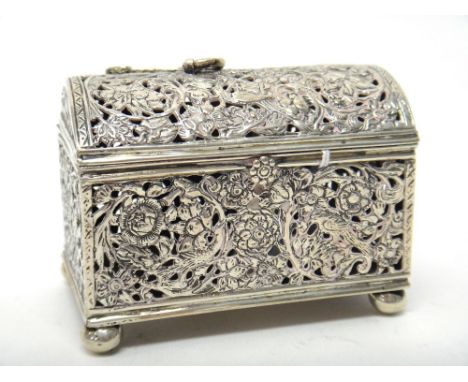 A European rectangular hinge lidded pot pouri box, of domed trunk form raised on four spherical feet, with cast floral and fo