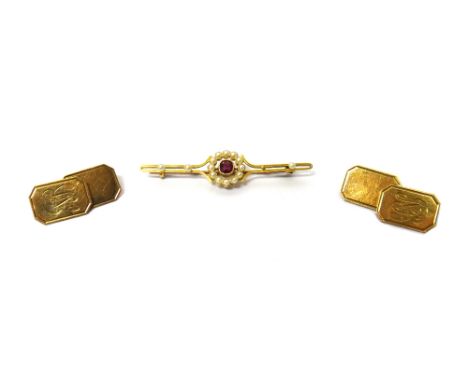 A gold, ruby and seed pearl set bar brooch, mounted with the cushion shaped ruby at the centre, within a surround of seed pea