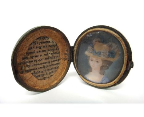 An oval portrait miniature of a lady, wearing a pale blue dress and with a light brown bonnet adorned with pink and blue ribb