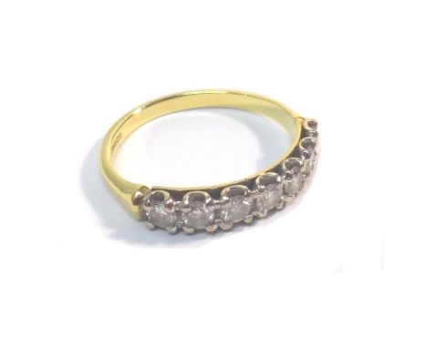 An 18ct gold and diamond set seven stone half hoop ring, mounted with a row of circular cut diamonds, ring size K, with a cas