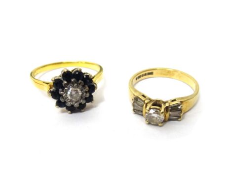 An 18ct gold, diamond and sapphire set cluster ring, mounted with the circular cut diamond at the centre, within a surround o