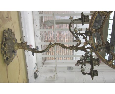 A gilt bronze five branch candelabra, early 20th century, the naturalistic tree base encrusted with porcelain flowerheads, co