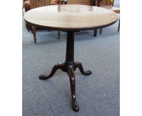 A George III mahogany circular snap top occasional table on carved tripod base, the top 71cm wide.