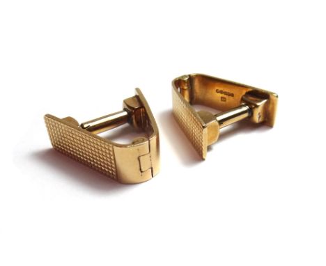 A pair of 9ct gold Kutchinsky cufflinks, each of hinged 'V' shaped form, with engine turned decoration, one London 1949, the 