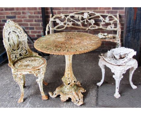 A 19th century cast iron white painted rustic pattern garden bench, 130cm wide (a.f), together with a similar circular table 