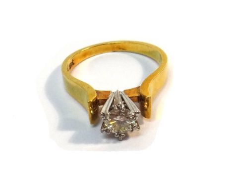 A gold and diamond set single stone ring, claw set with a circular cut diamond in a raised setting, detailed 18 CT, ring size