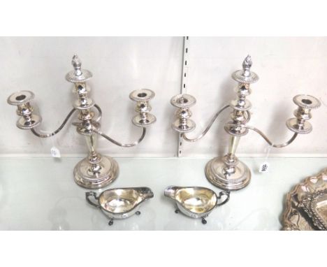A pair of plated adjustable three light table candelabra, each with fluted scrolling arms and on gadrooned circular bases, th