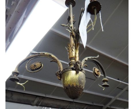 A pair of Edwardian gilt bronze three light chandeliers, early 20th century with downswept branches and rams head mounts, lac