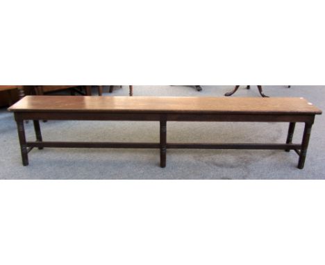 A 19th century oak rectangular bench on six turned supports, 214cm wide.