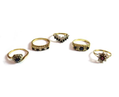 A 9ct gold, sapphire and diamond set ring, mounted with three cushion shaped sapphires, alternating with two pairs of small d