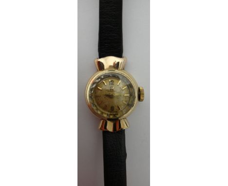 A lady's 9ct gold circular cased Omega wristwatch, with a signed jeweled movement, the signed circular dial with gilt Arabic 
