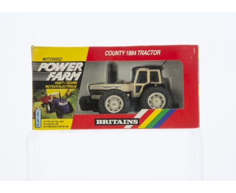 Britains boxed Powerfarm series set 9324 County 1884 Tractor, wheel hubs beginning to 'melt', otherwise VG in G box, slight w