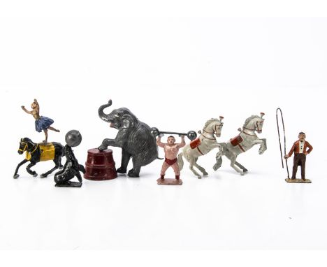 Charbens lead Circus figures in good condition comprising strongman with bar bell, ringmaster, seal balancing ball, liberty h