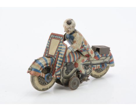 A Mettoy Tinplate Clockwork Clown Motorcycle, detailed tinprinted motorcycle with Clown rider, '1st Prize' on his back, lead 