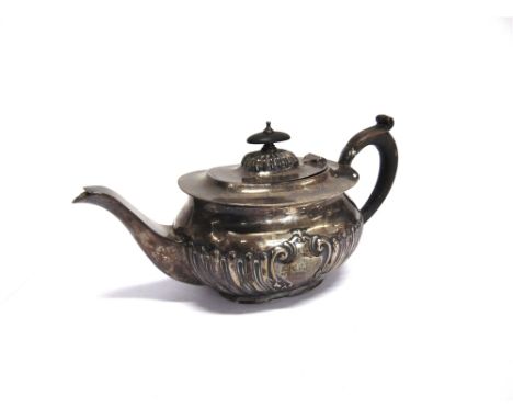 A SILVER TEAPOT by J Round, Sheffield 1911, of embossed rounded rectangular form, 24cm long, 351g (11.3 troy ozs) gross