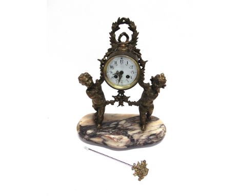 A FRENCH FIGURAL MANTLE CLOCK  the 9-day movement striking on a bell, stamped 'MOUGIN', supported by pair of winged cherubs, 