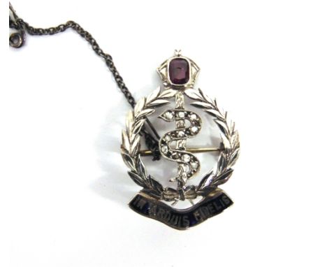 A ROYAL MEDICAL CORPS RUBY AND ROSE DIAMOND SET SWEETHEART BROOCH in unmarked white metal, 3.2cm high, 3.6g gross