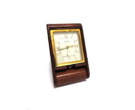 A JAEGER LE COULTRE 8 DAY TRAVELLING ALARM CLOCK in a folding leather covered case, numbered 098344, dial approximately 5.2cm