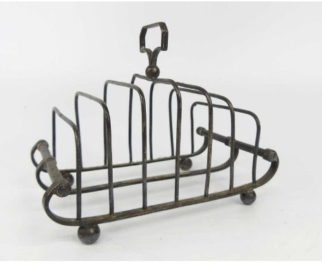 A George III silver six division toast rack, with reeded angular handle upon a ball to the central divider, attached to a sle