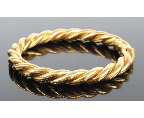 An 18ct yellow gold ropetwist oval hinged bangle, with box clasp, bangle w.8.3mm, dia. 65 x 55mm, gross weight 42g, hallmarke