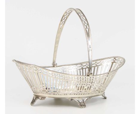 An Edwardian silver swing-handled basket, of elliptical form, having pierced sides with decorative borders, beaded rim, and s