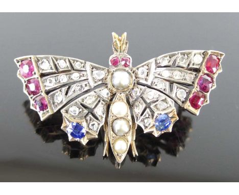 A late Victorian yellow and white metal multi-stone butterfly brooch, comprising 28 rose cut diamonds, six oval cut rubies, a