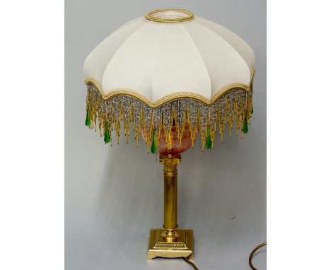 A late Victorian oil lamp now converted for electricity, cranberry glass bowl to stem, shade with green glass drop and bead f