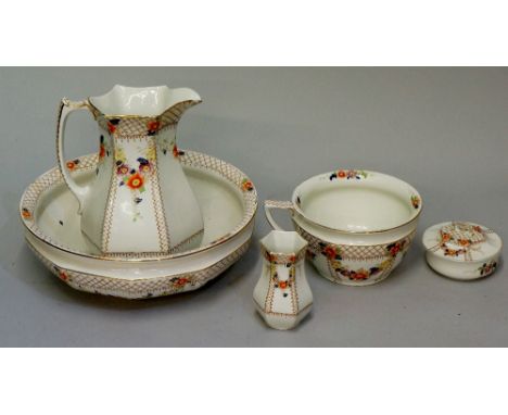 A late Victorian bedroom set comprising wash jug and basin, vase, soap dish and chamber pot, brown transfer deign with multic