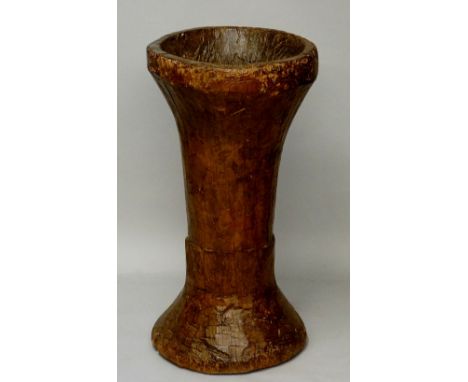 A waisted carved tree trunk vessel, 82.5cm high, 42.5cm wide (faults)