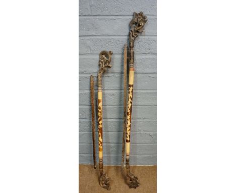 A near pair of long wood carvings, possibly meant to add decoration at the head and foot of a bed, carved floral finials, the