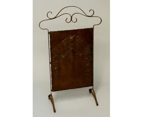 A copper fire screen with floral design of roses and drapery in relief to body, 82cm high