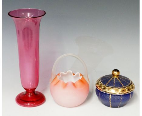 A Victorian cranberry glass trumpet form vase, 23cm high, 9cm diameter; a blue glass lidded powder bowl with gilt and enamel 