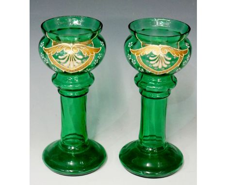A pair of late 19th / early 20th Century green glass vases, globular upper bowls with gilt and enamel design, hollow stems an