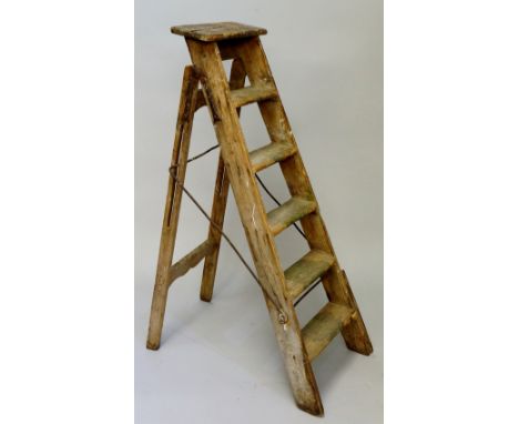 A wooden step ladder, 135cm high when folded up (faults)
