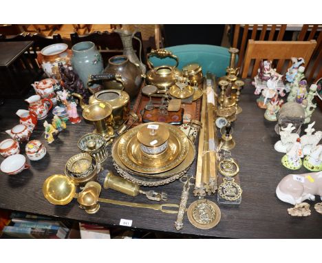 A collection of various brass ware to include candlesticks, horse brasses, postal scales, stair rods etc.