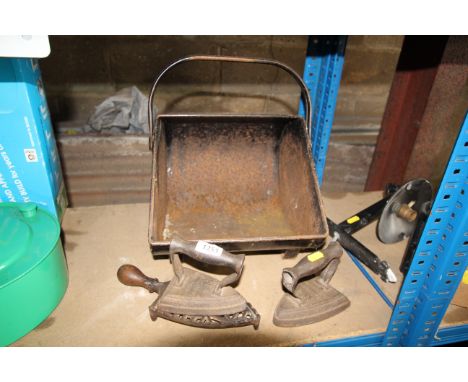 A coal scuttle, two vintage flat irons and a trivet