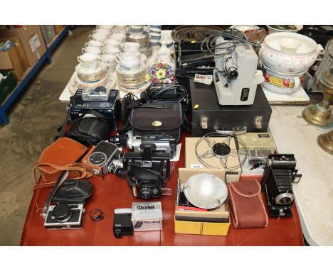 A quantity of various cameras to include Polaroid, Panasonic, Brownie, Eumig projector etc.