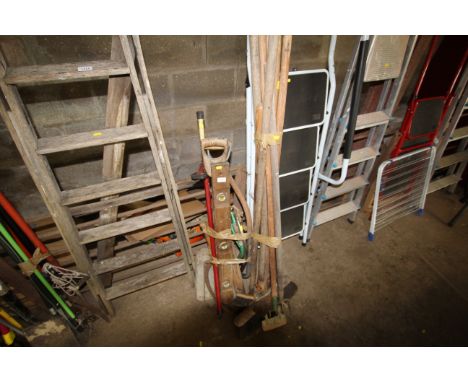 A quantity of long handled garden tools to include hoes, brushes, levels, bow saw, shovels etc.