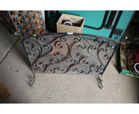 An ornate metal fire screen