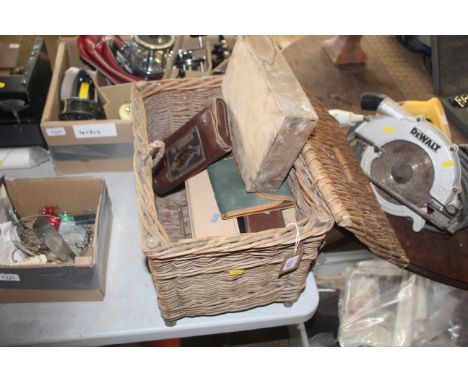 A vintage wicker fishing basket and contents of fishing items
