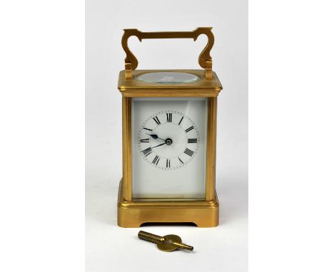 Brass carriage time piece, with white enamel dial and Roman numeral chapter ring, with gong strike, 13.5cm high
