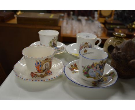 Four commemorative tea cups and saucers 