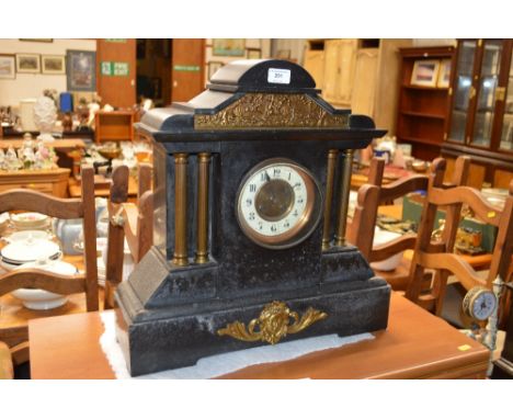 A late Victorian black slate two hole mantle clock with architectural form  