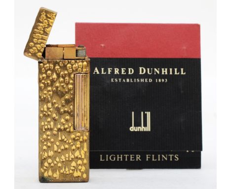 Dunhill, a rollagas gold plated cigarette lighter, with a packet of lighter flints. 