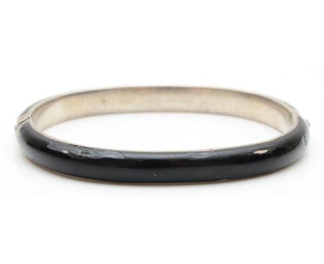 A late 19th century silver and black enamel hinged bangle, 17gm 