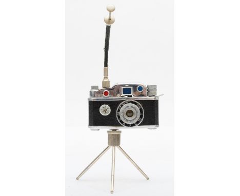 A vintage novelty Photolite Japanese cigarette lighter in the form of a miniature camera complete with miniature tripod and c