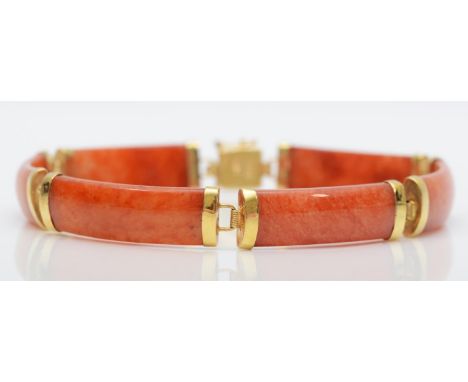 A Chinese 14K gold mounted orange jade panel link bracelet, untested for colour enhancement, 18cm 