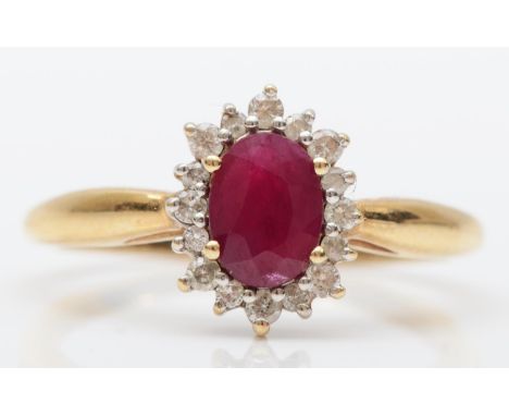 A 9ct gold ruby and brilliant cut diamond cluster ring, O, 2.1gm 